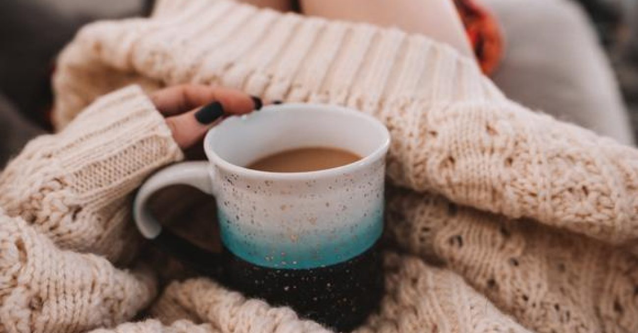 hygge woman in woolly jumper with cup of tea